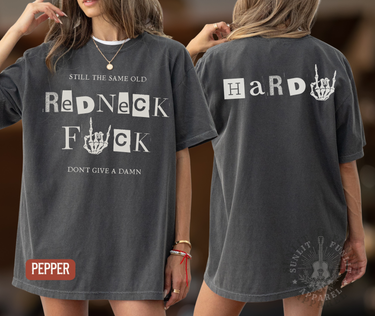 a woman wearing a grey t-shirt with text and graphics on it.